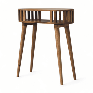 Angled view of a mid-century modern console table with slatted design and open storage. Made from solid mango wood with a light finish.