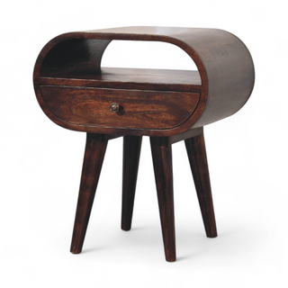 Angled view of the oval nightstand showcasing its open shelf, single drawer, and tapered legs.