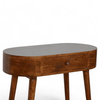 Close-up front view of a round wooden table with a single drawer and tapered legs, showcasing its chestnut finish.