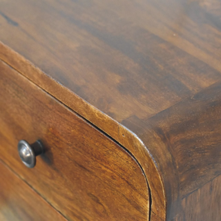Close-up of the wood grain texture on the top surface of the nightstand.