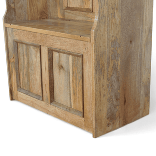 Rear corner view of a mango wood monk's bench showing the panelled back and side storage construction
