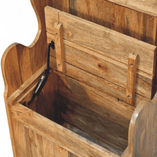 Natural mango wood settle bench with the hinged seat raised to reveal the interior storage box