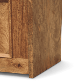 Side view of a natural mango wood settle bench showing the solid panelled end and storage box base