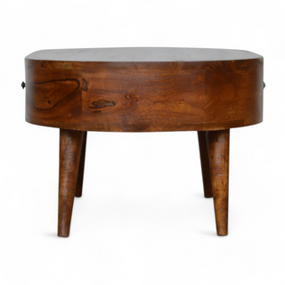 Side view of the oval wooden coffee table showcasing its smooth wooden finish, tapered legs, and slim profile.