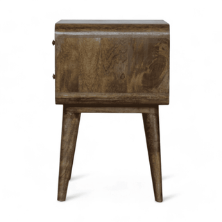Side angle close-up of a grey-washed nightstand showcasing its elegant Scandinavian legs.