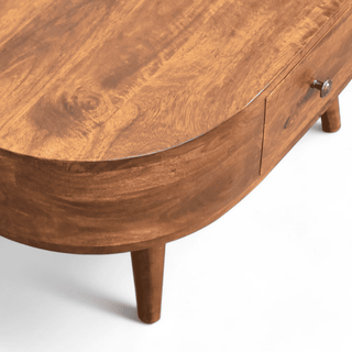 Top-down view of the oval coffee table showing the centered drawer and its spacious surface area.