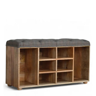 Mango wood shoe storage bench with tufted grey seat and multiple open cubbies shown at a front three-quarter angle
