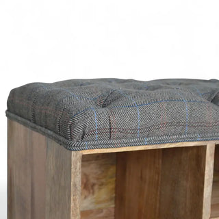 Close-up of the mango wood base, turned bun foot, and grey cushioned edge of a shoe storage bench