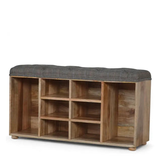 Upholstered storage bench with grey tweed top and wooden shoe cubbies shown from the opposite angle