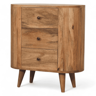 Angled front view of the mini cabinet showcasing its curved frame, oak-inspired finish, and three drawers with round knobs.