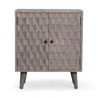 Front view of a light grey wooden cabinet with hexagonal carvings and two round black knobs.
