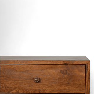 Close-up of the drawers and geometric door on the vintage sideboard, showcasing detailed craftsmanship and smooth wood grain.