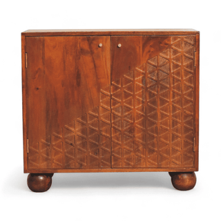 Front view of a vintage mid-century modern storage cabinet in solid mango wood, featuring a carved geometric pattern on the doors and rounded legs.