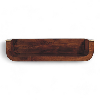Straight front view of a dark wooden floating wall shelf with curved edges and brass accents, emphasizing its minimalist design.
