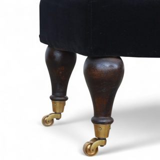 Leg detail view of Black Velvet Upholstered Bench with Castor Legs, showing the upholstered seat, legs and silhouette