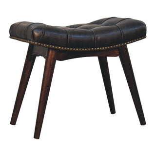 Angled view of Cali Upholstered Bench Black Buffalo Leather Button Tufted Curved Saddle Brass Studs California Walnut