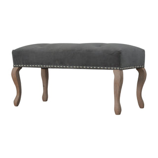 Angled view of Cinder Bedroom Bench Charcoal Grey Velvet Button Tufted Antique Brass Studs French Cabriole