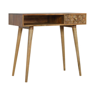 Side angle view of Facet Writing Desk Mango Wood Diamond Cube-Carved Drawer with Brass Knob