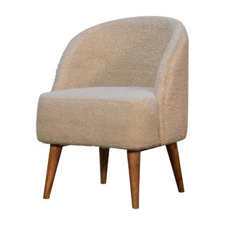 Angled view of Fleur Tub Chair Cream bouclé Nordic Oak Tapered Leg, showing the upholstered seat, legs and silhouette