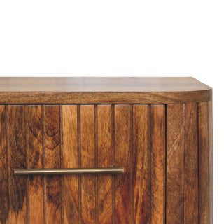 Fluted bedside front close-up showing fluted panel texture and drawer knob detail