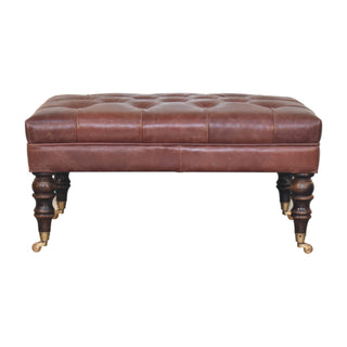 Front view of Harlow Ottoman Bench Chestnut Brown Buffalo Leather Hand-Tufted Brass Castor Legs