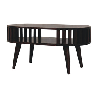 Side angle view of Kira Oval Coffee Table Solid Mango Wood Vertical Slat Sides Lower Shelf Walnut