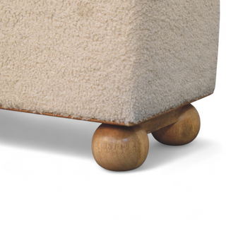 Rear angle view of Mid Century Modern Bouclé Lid-Up Storage Ottoman, showing the upholstered seat, legs and silhouette
