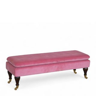 Angled view of Mid-Century Modern Pink Velvet Bench with Castor Legs, showing the upholstered seat, legs and silhouette