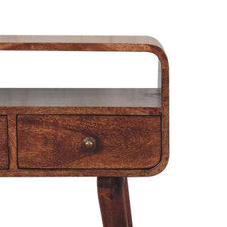 Close-up of finish detail on Mini Curved Honey Caramel Console Table, showing the tabletop, frame and furniture finish