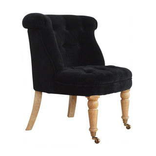 Angled view of Onyx Accent Chair Black Velvet Buttoned Tub Caster Oak Leg