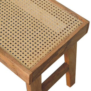 Leg detail view of Open Rattan Bench, showing the seat, legs and furniture silhouette