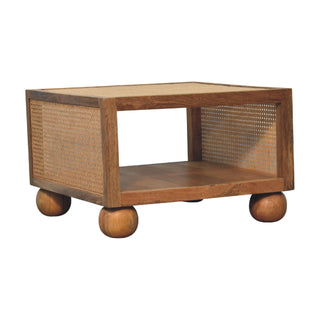 Side angle view of Reed Small Coffee Table Solid Mango Wood Woven Cane Panels Open Shelf Ball Feet