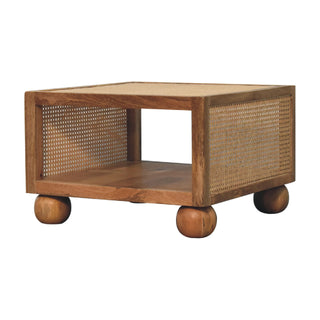 Front view of Reed Small Coffee Table Solid Mango Wood Woven Cane Panels Open Shelf Ball Feet