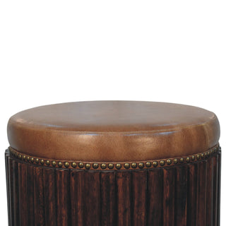 Ribbed leather accent stool front close-up showing ribbed leather panel detail