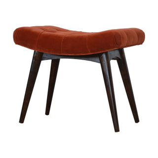 Angled view of Rust Upholstered Bench Brick Red Velvet Button Tufted Curved Saddle Near-Black Nordic Legs