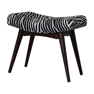 Angled view of Zara Upholstered Bench Zebra Print Velvet Curved Saddle Seat Splayed Legs